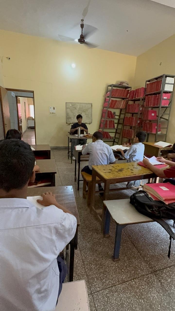 A wider view of the classroom during the lesson, with students seated at rows of desks