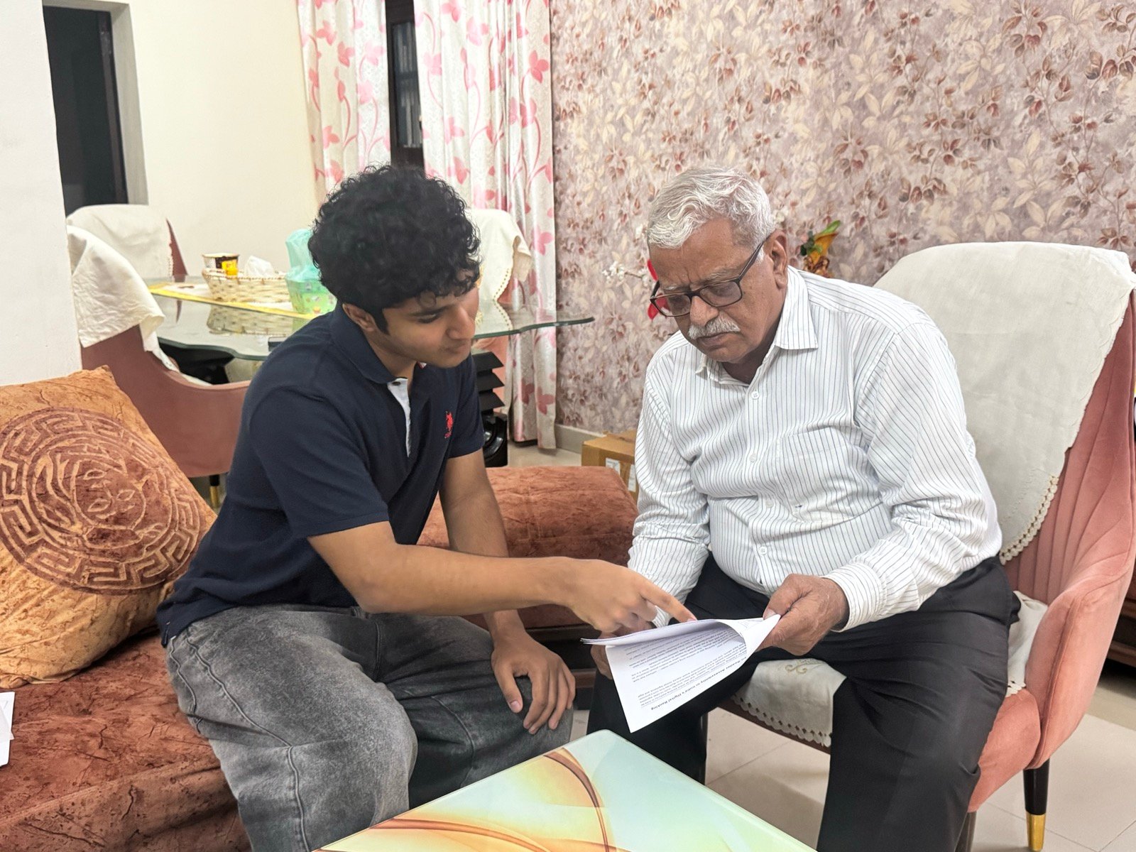 Pointing to a section of the policy brief while Mr. Tilak Raj Malhotra reviews it