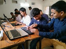 Students working on laptops at the audio library